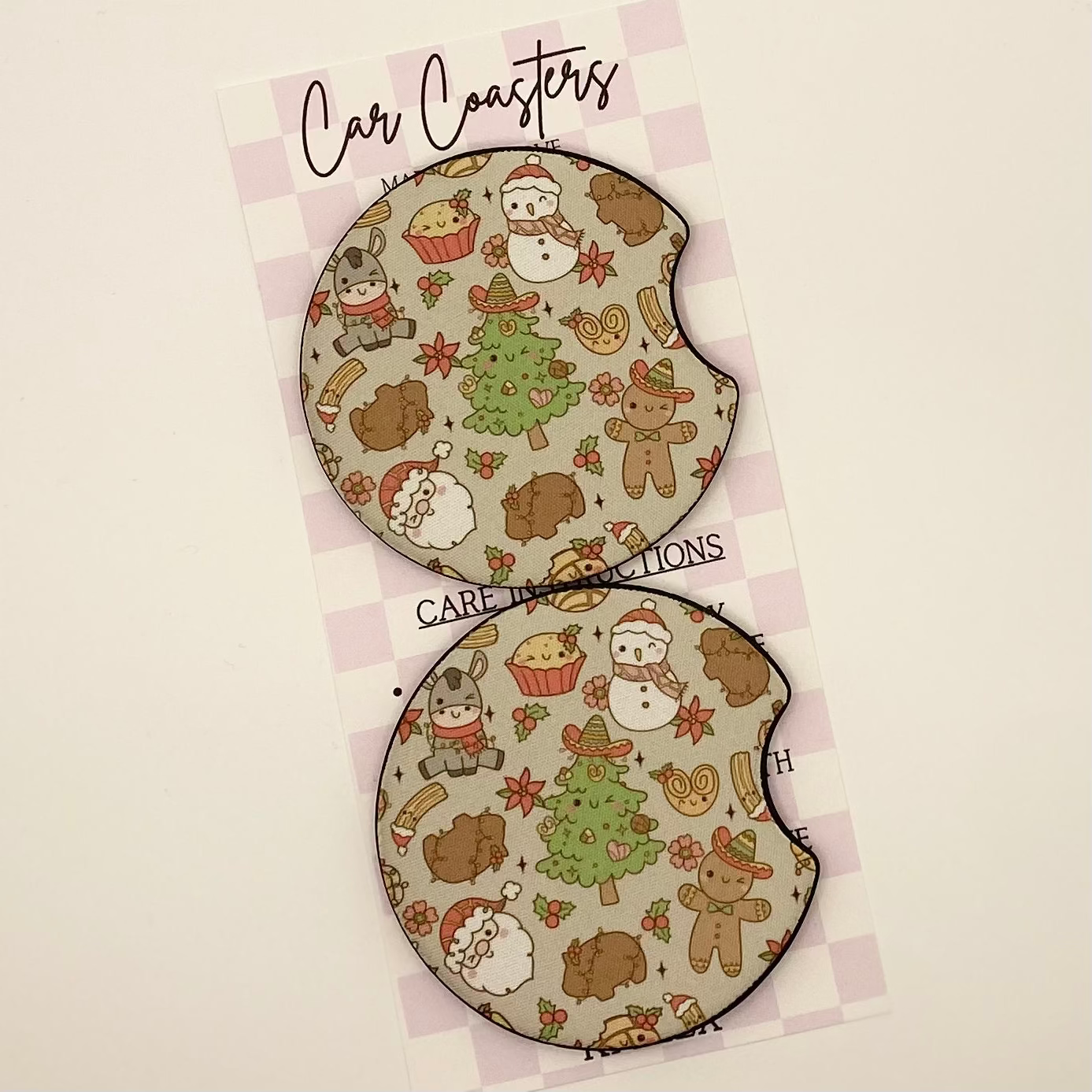 Two round coasters with Christmas-themed design on a white background