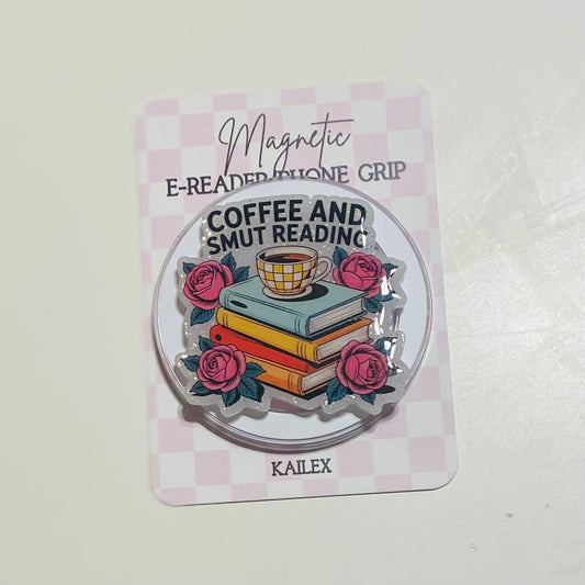 Magnetic e-reader phone grip with books, coffee cup, and roses on a checkered background