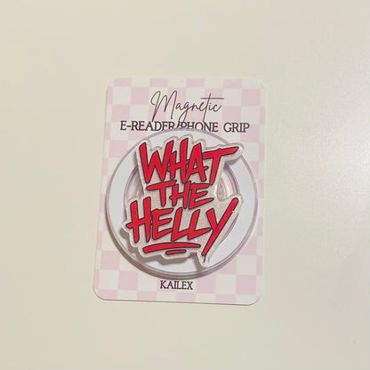Round metal badge with red text 'WHAT THE HELLY' 