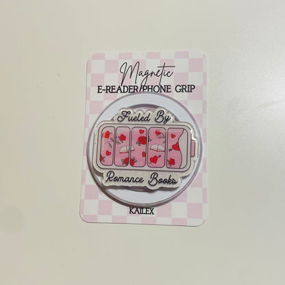 Magnetic e-reader phone grip with 'Fueled By Romance Books' design on a checkered background