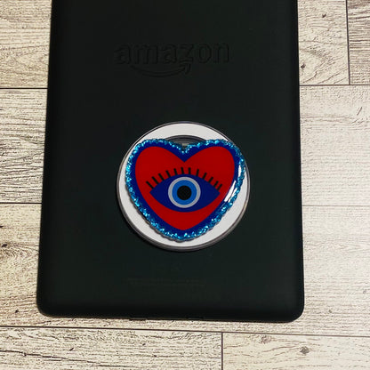 Heart-shaped e-reader phone grip with eye design 
