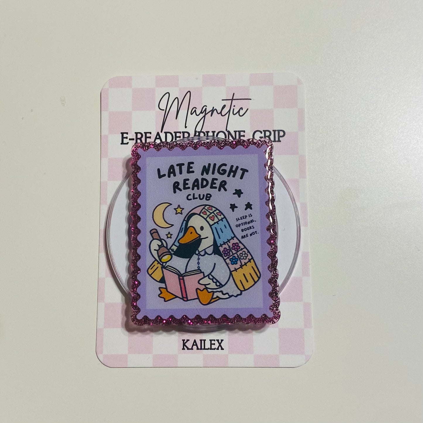 Magnetic e-reader phone grip with cartoon duck design on a checkered card, brand 'KAILEX' visible.