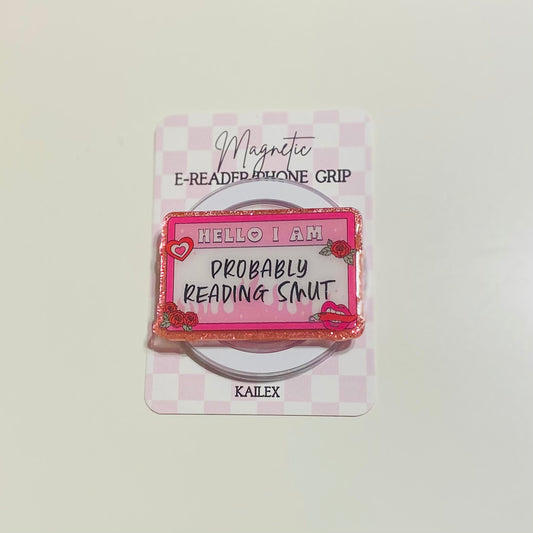 Magnetic e-reader phone grip with text on a checkered background