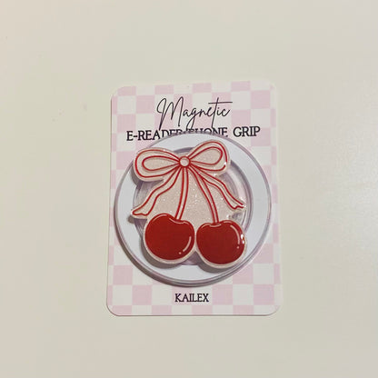 Magnetic e-reader phone grip with cherry design on a checkered background