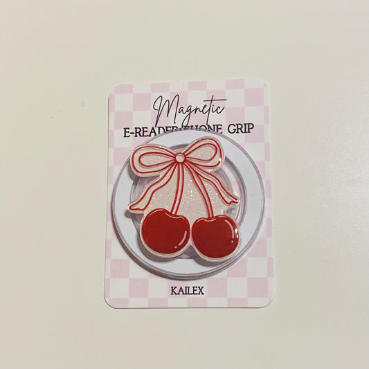 Magnetic e-reader phone grip with cherry design on a checkered background