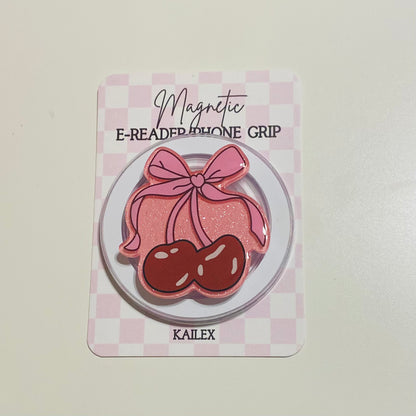 Magnetic e-reader phone grip with pink bow and cherries on a checkered card, brand 'KAILEX' visible