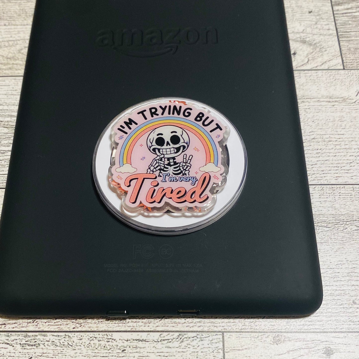 Magnetic e-reader phone grip with cartoon character and text