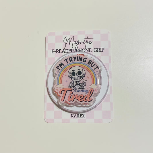 Magnetic e-reader phone grip with cartoon character and text on a checkered background