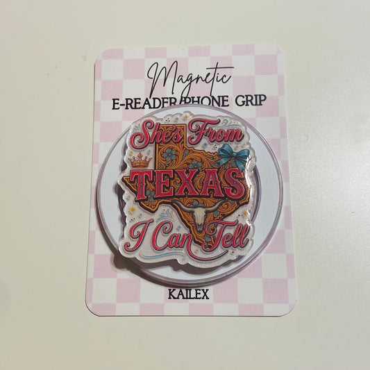 Magnetic e-reader phone grip with 'She's from Texas I can tell' design on a checkered card