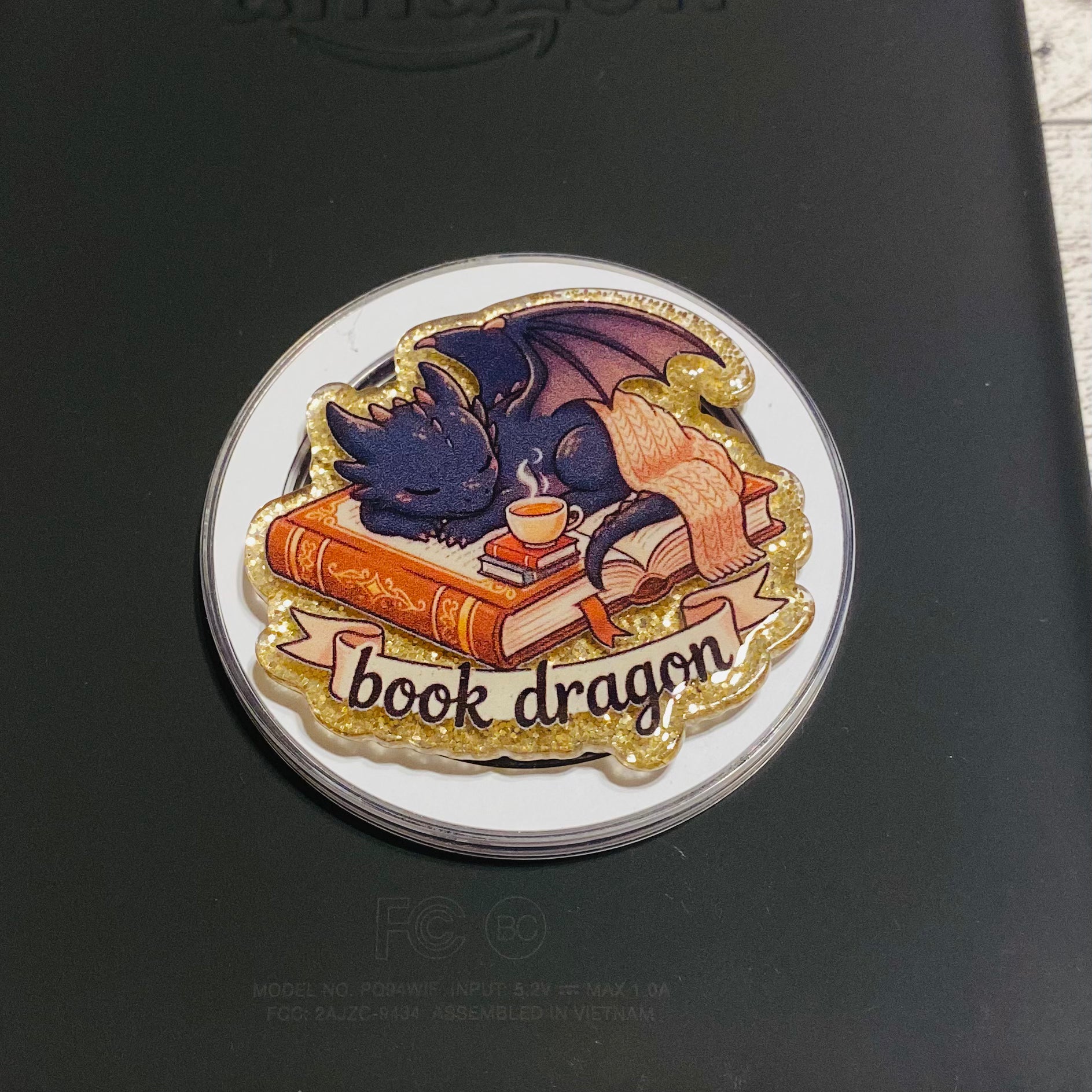 Magnetic e-reader phone grip with 'book dragon' design 