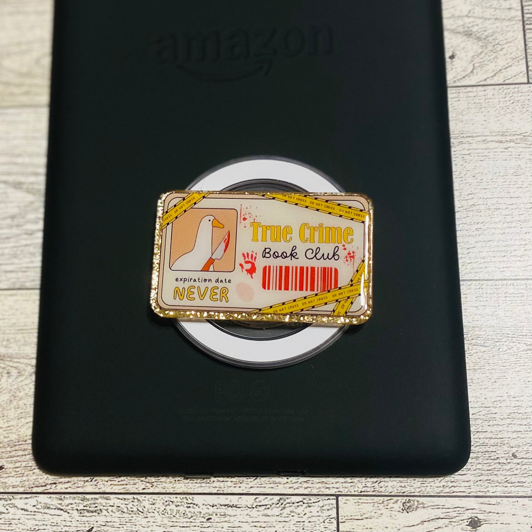 Magnetic e-reader phone grip with 'True Crime Book Club' design 