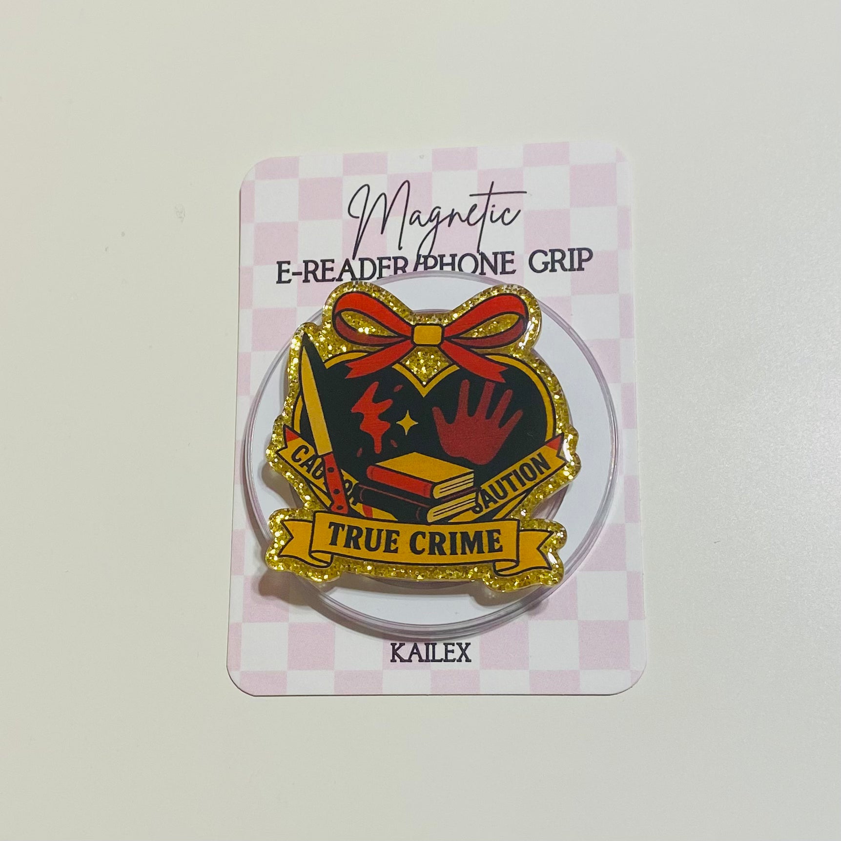 true crime with yellow caution tape with red bow grip on checkered backing card