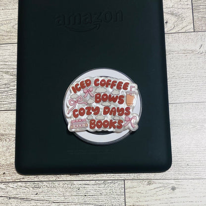Magnetic e-reader phone grip with 'iced coffee, cozy days, books' text