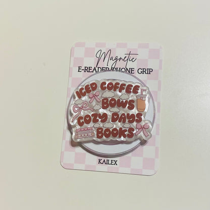Magnetic e-reader phone grip with 'iced coffee, cozy days, books' text on a checkered background