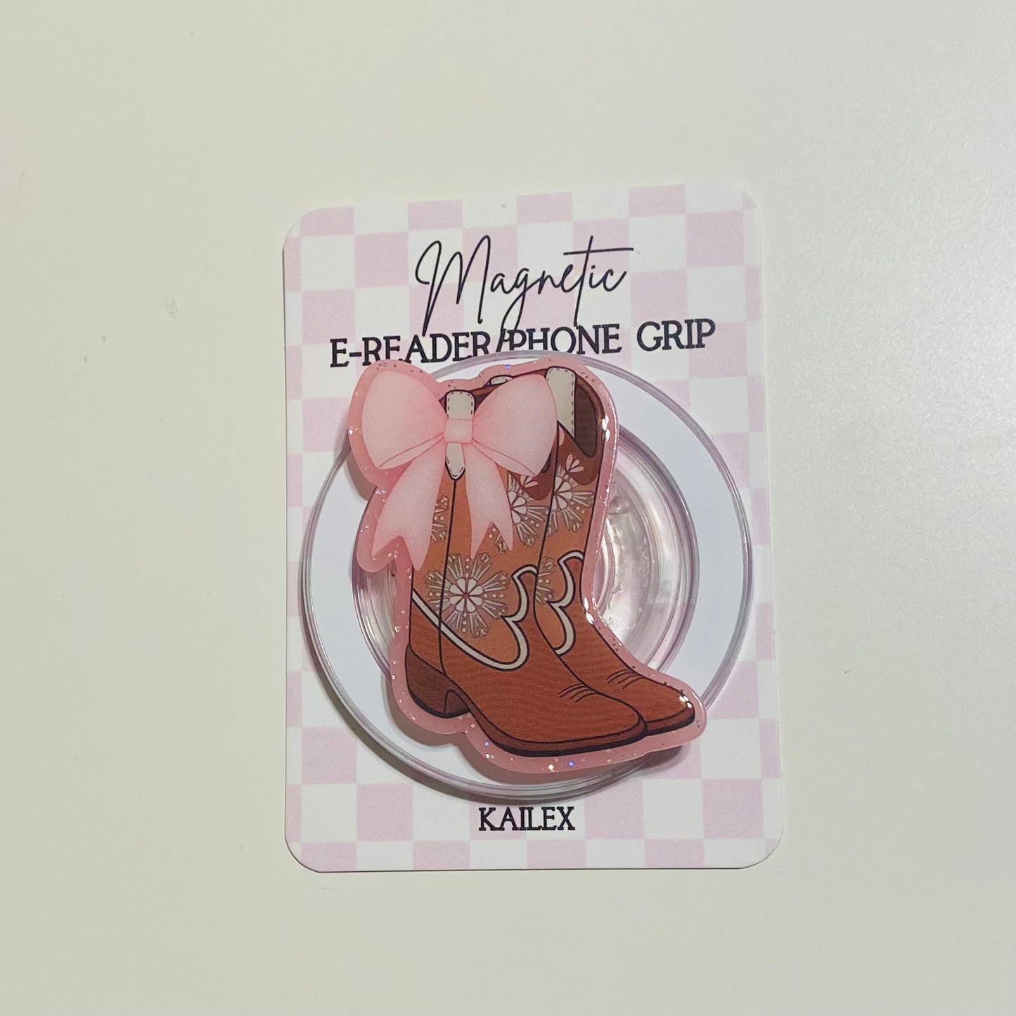 Magnetic e-reader phone grip with cowboy boot design on a checkered card