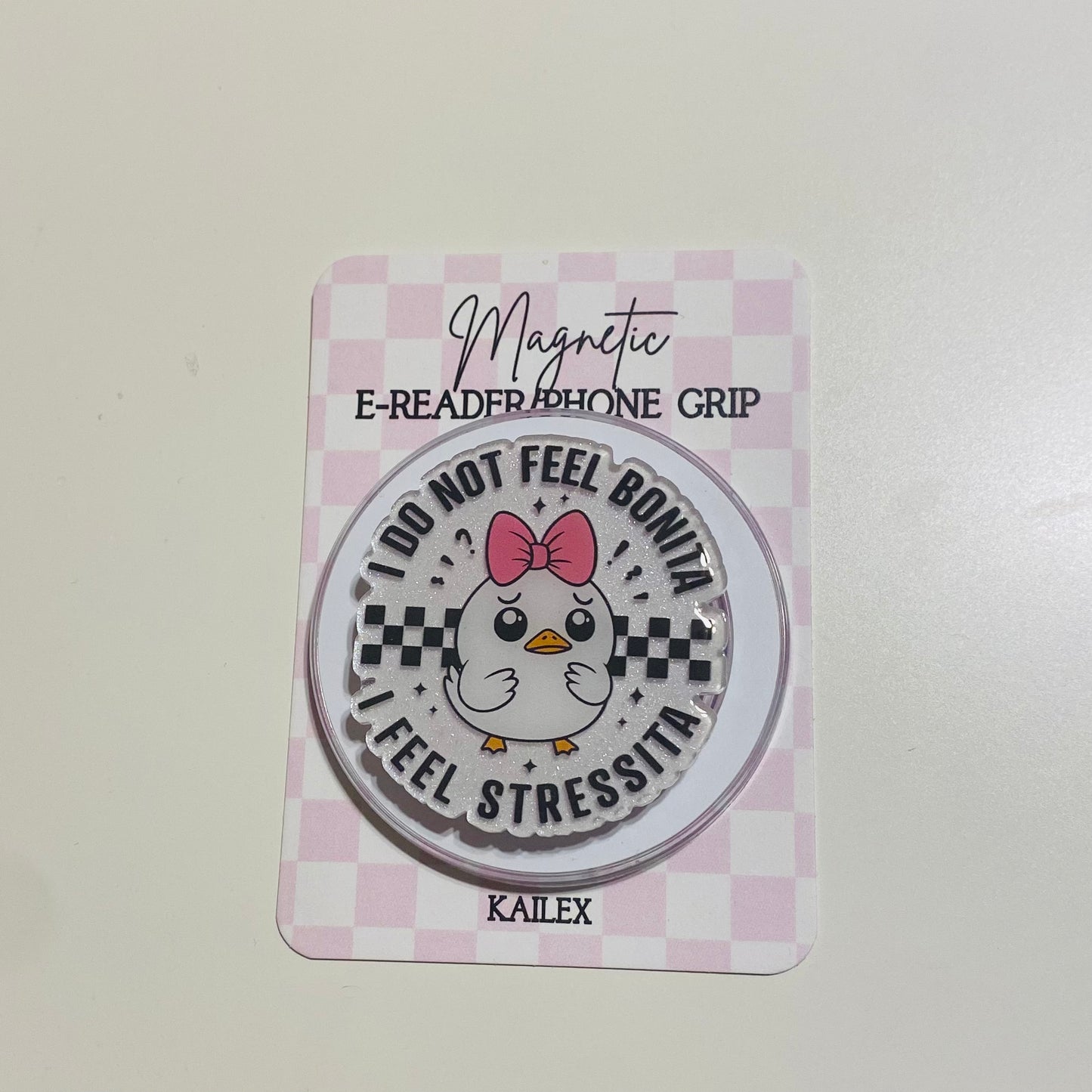 Magnetic e-reader phone grip with cartoon chicken design on a checkered card