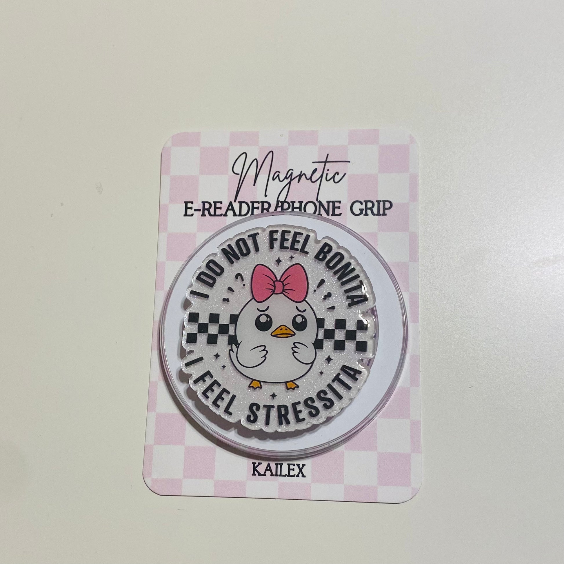 Magnetic e-reader phone grip with cartoon chicken design on a checkered card