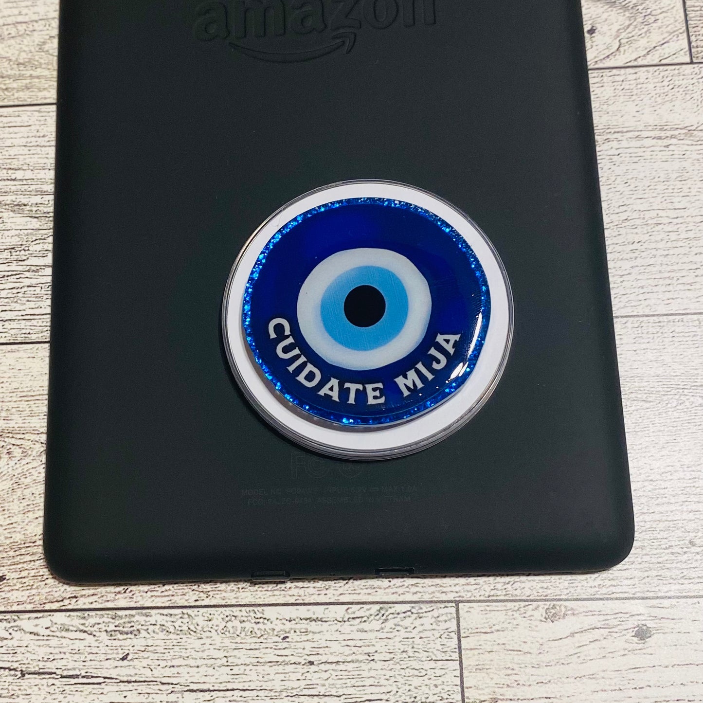 Black case with a blue and white circular design on a wooden surface