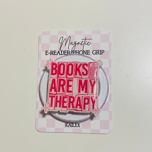 Magnetic e-reader phone grip with 'Books are my therapy' text on a checkered background