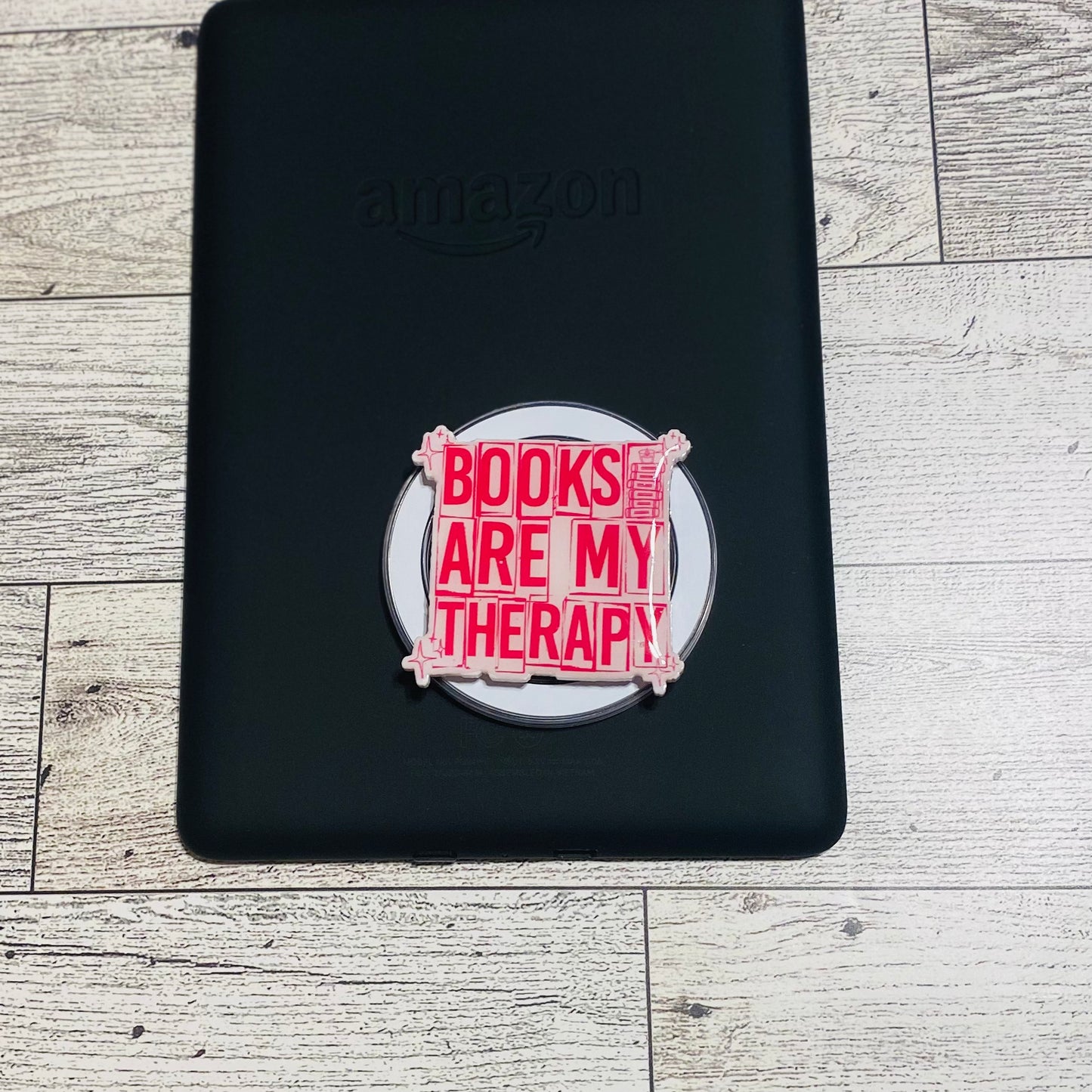 Magnetic e-reader phone grip with 'Books are my therapy' text 