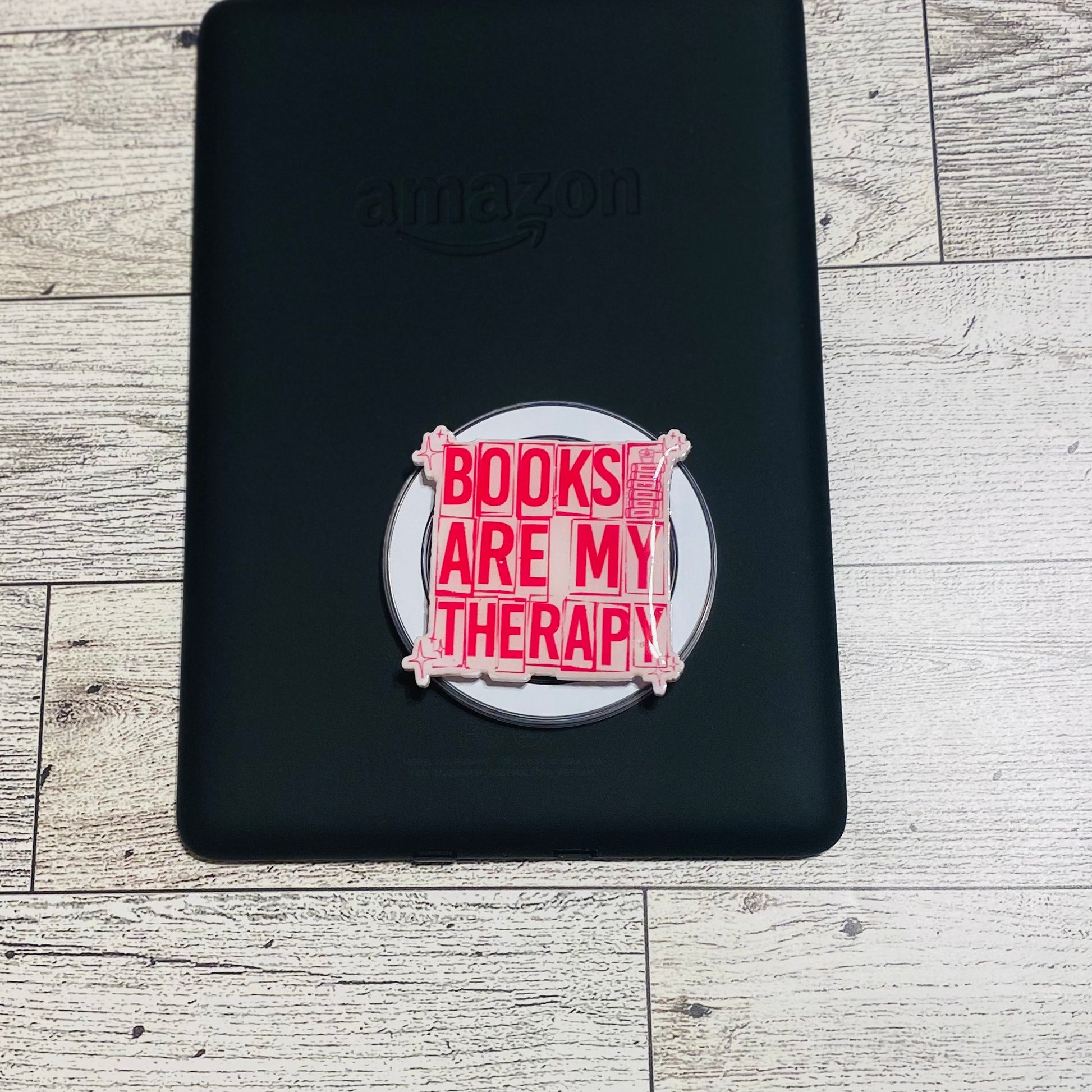 Magnetic e-reader phone grip with 'Books are my therapy' text 
