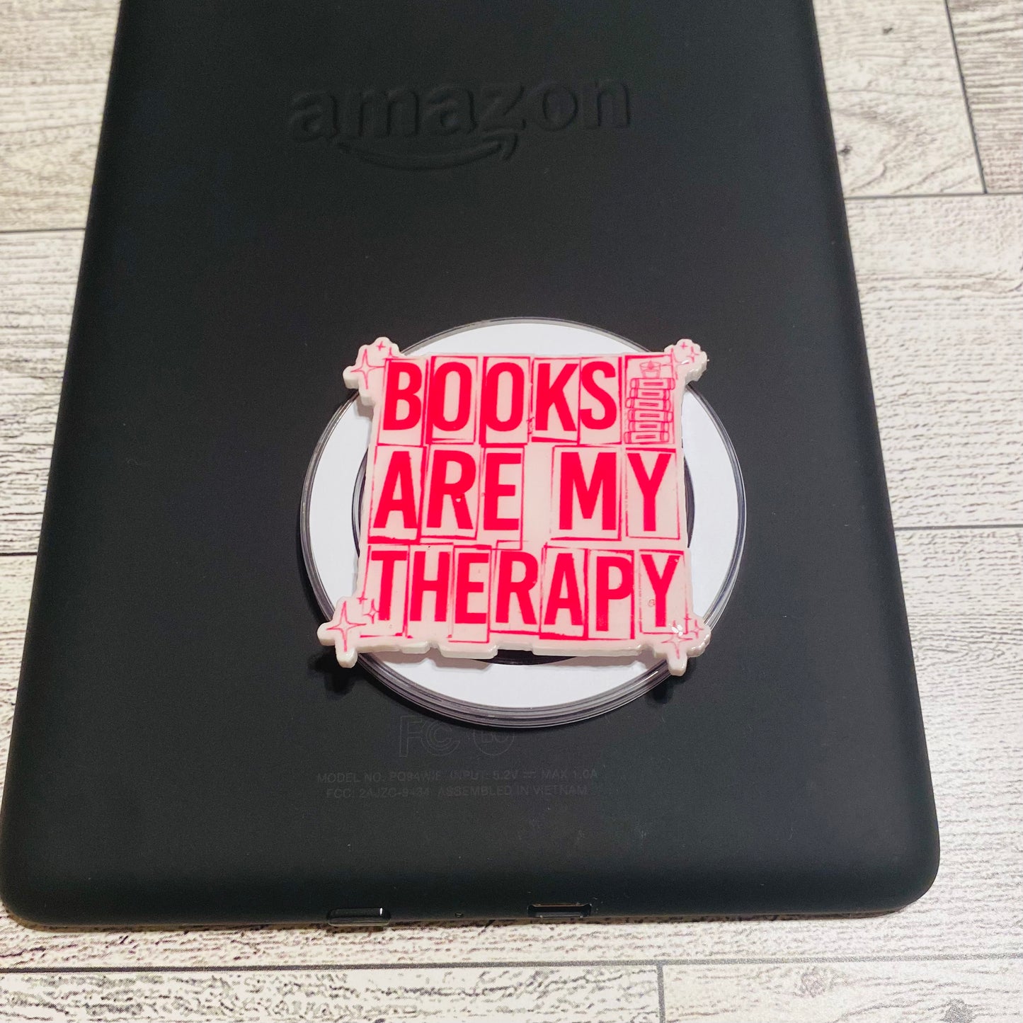 Magnetic e-reader phone grip with 'Books are my therapy' text 