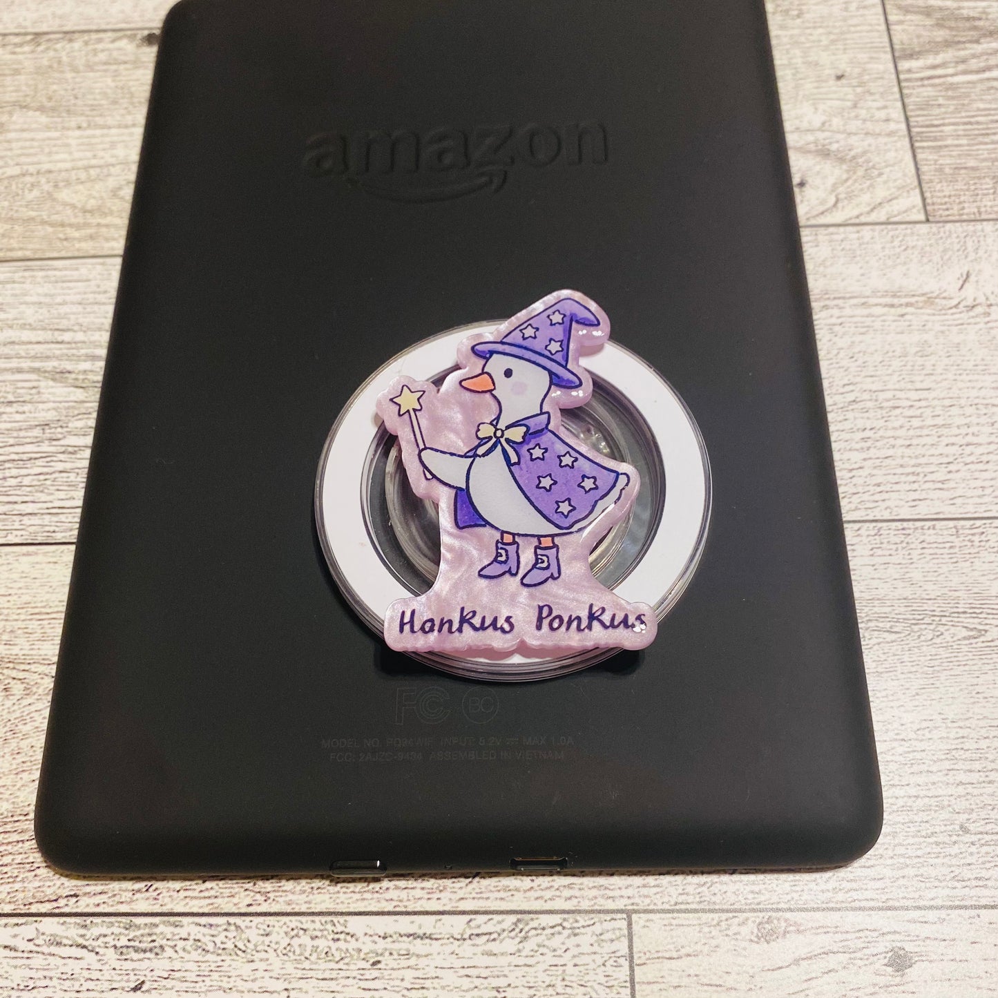 Magnetic e-reader phone grip with cartoon character