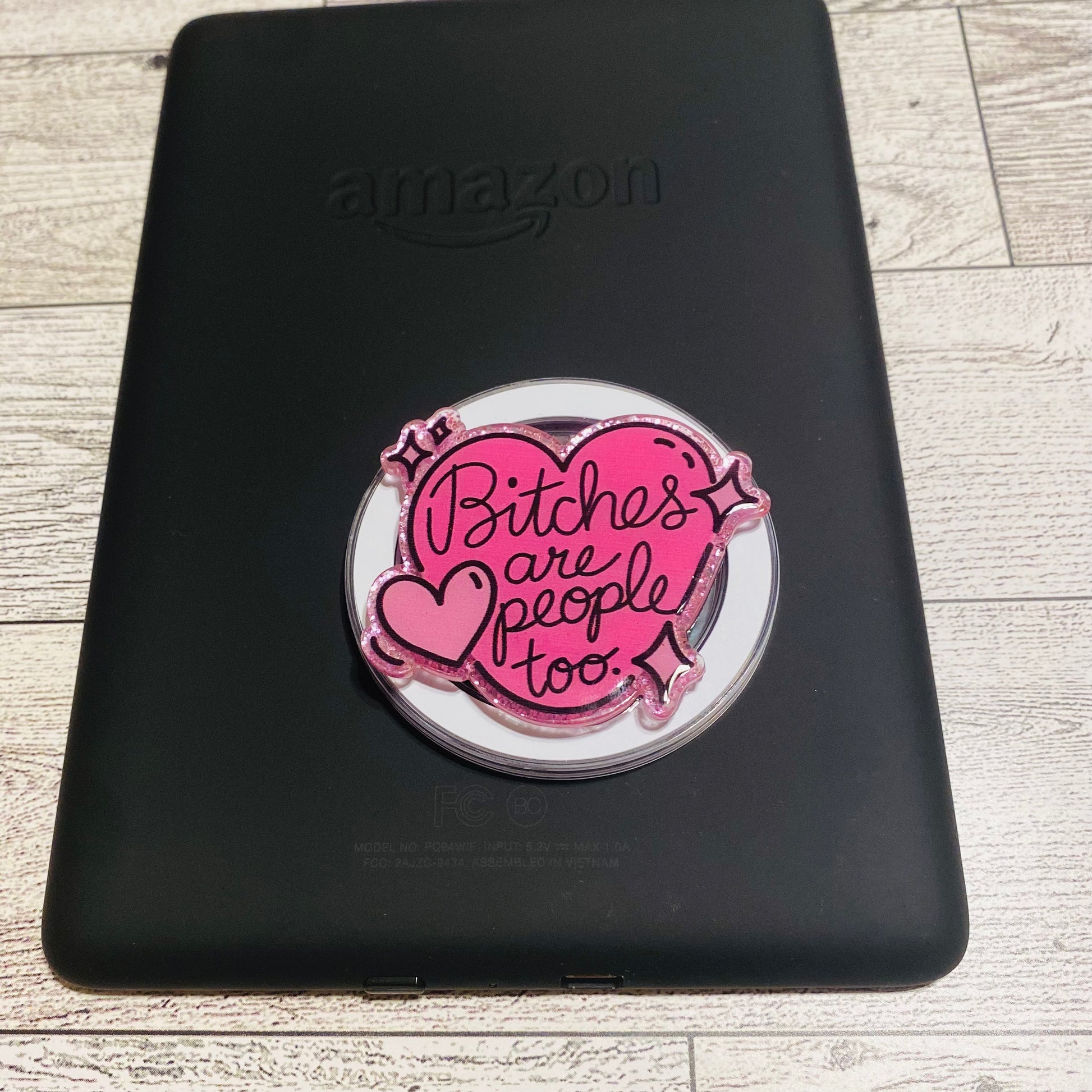 Pink magnetic e-reader phone grip with text 