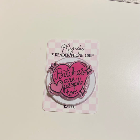 Pink magnetic e-reader phone grip with text on a checkered card