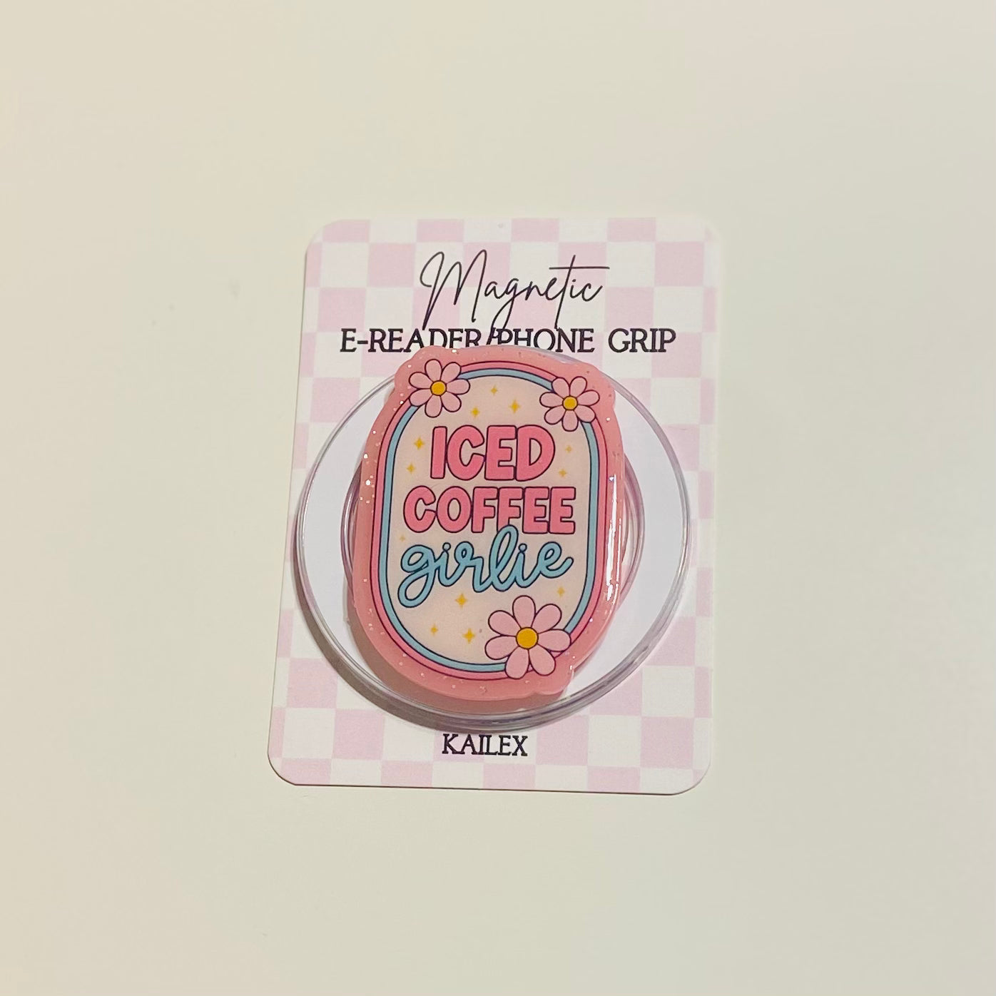 Magnetic e-reader phone grip with 'Iced Coffee Girlie' design on a checkered background