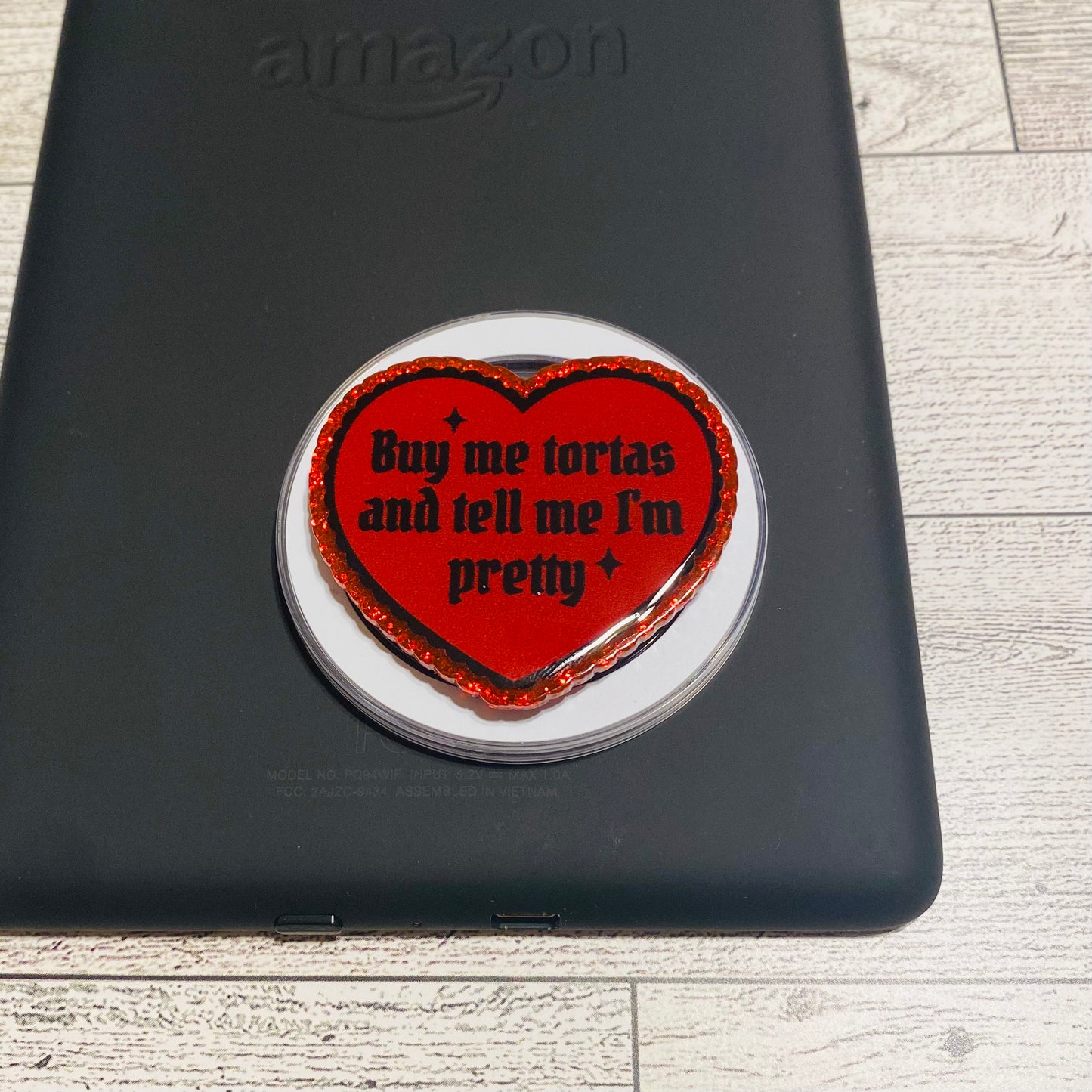 Red heart with text saying buy me tortas and tell me im pretty on black amazon device