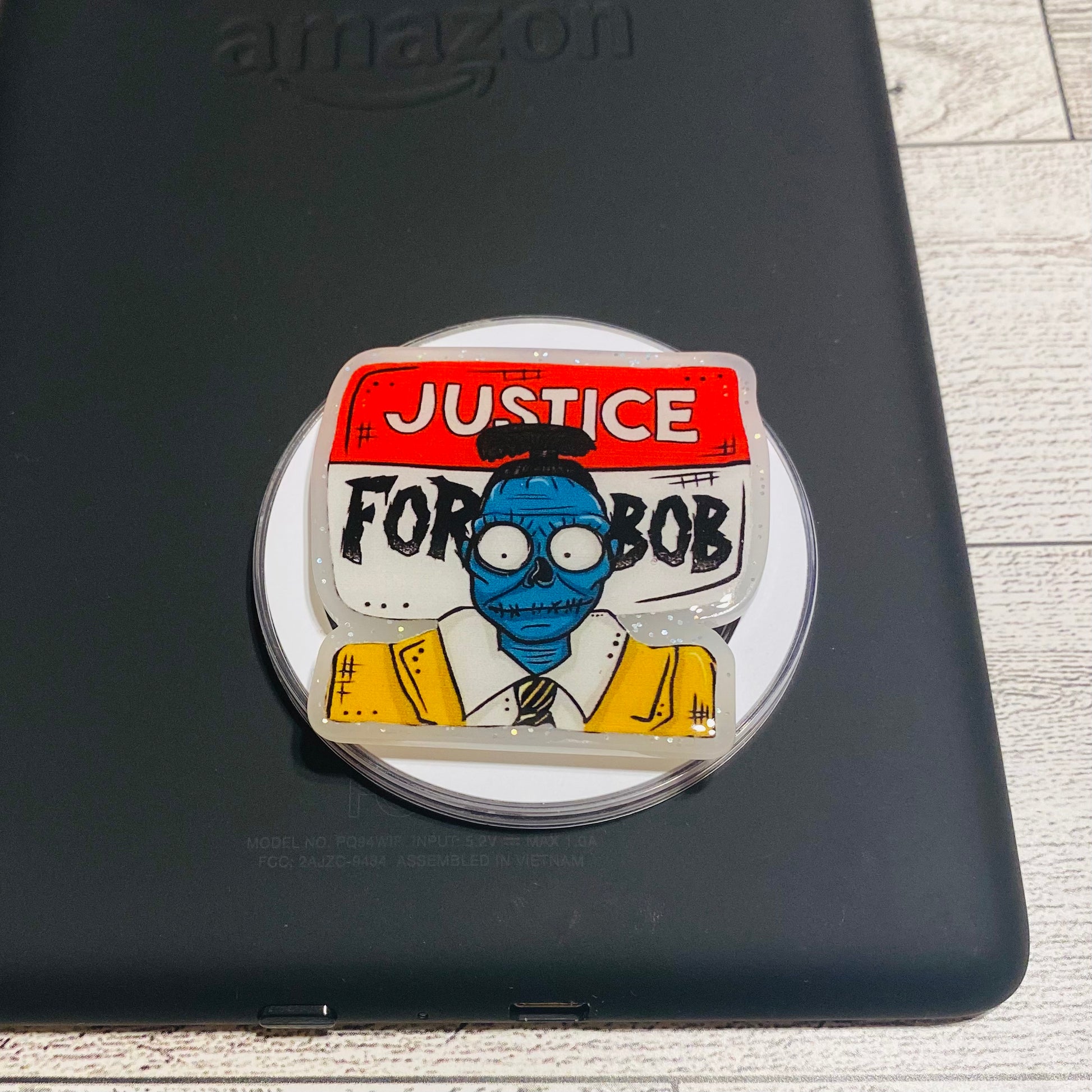 Magnetic e-reader phone grip with 'Justice for Bob' design 