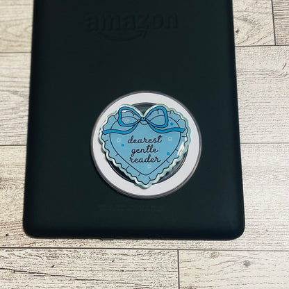 Blue heart-shaped e-reader phone grip with bow design