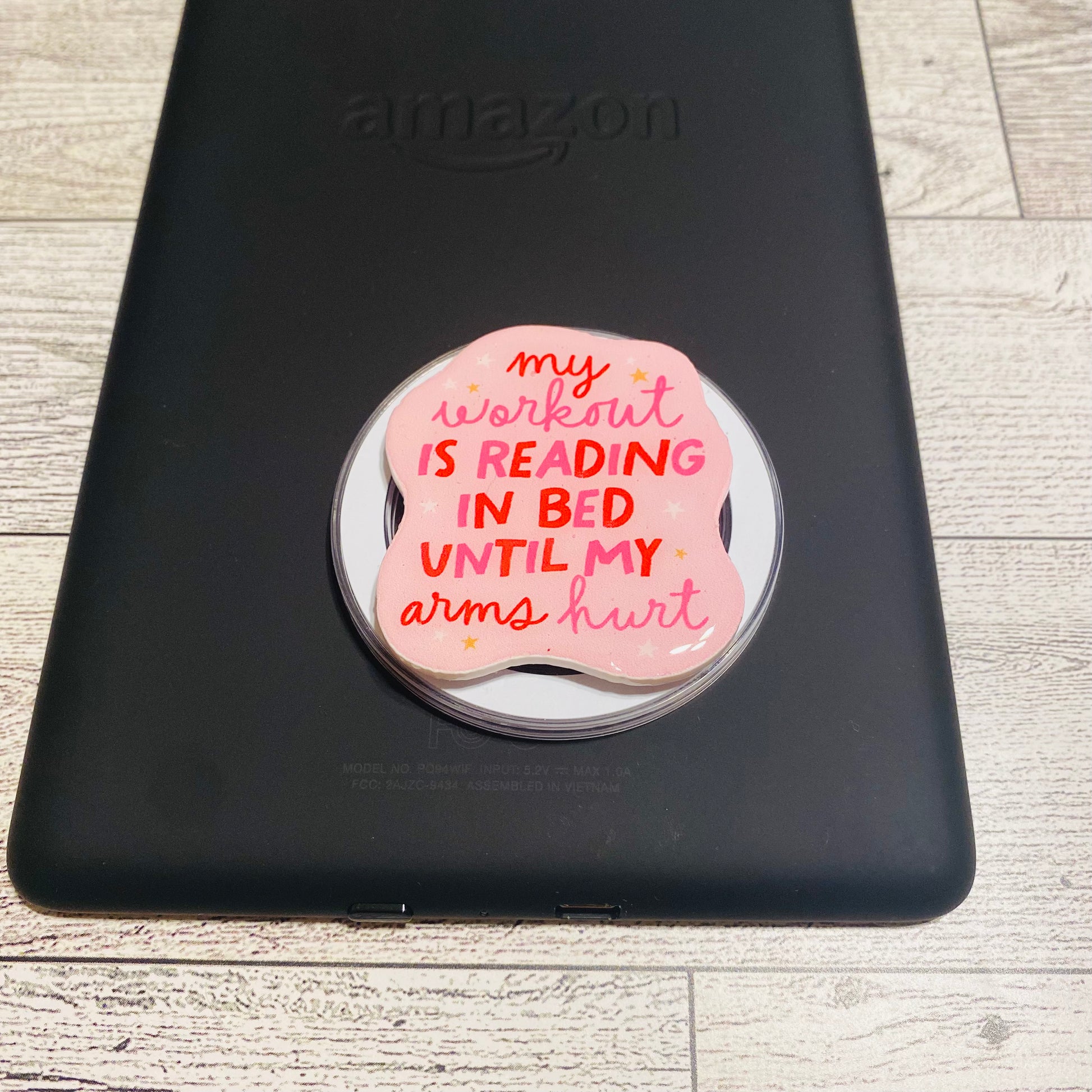 Magnetic e-reader/phone grip with pink design and text 