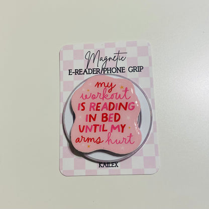 Magnetic e-reader/phone grip with pink design and text on a checkered background