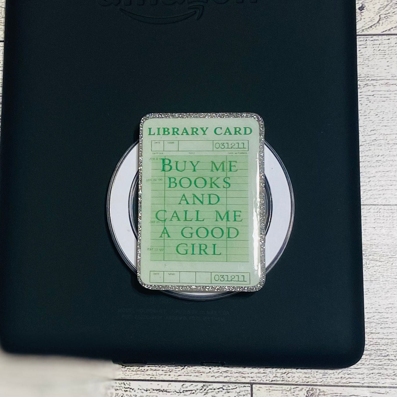 Magnetic e-reader book grip with green 'library card' design 