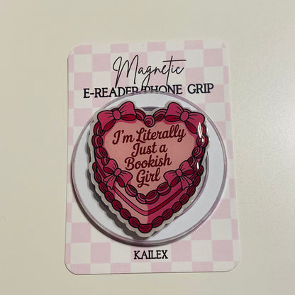 Heart-shaped magnetic e-reader phone grip with text on a checkered background