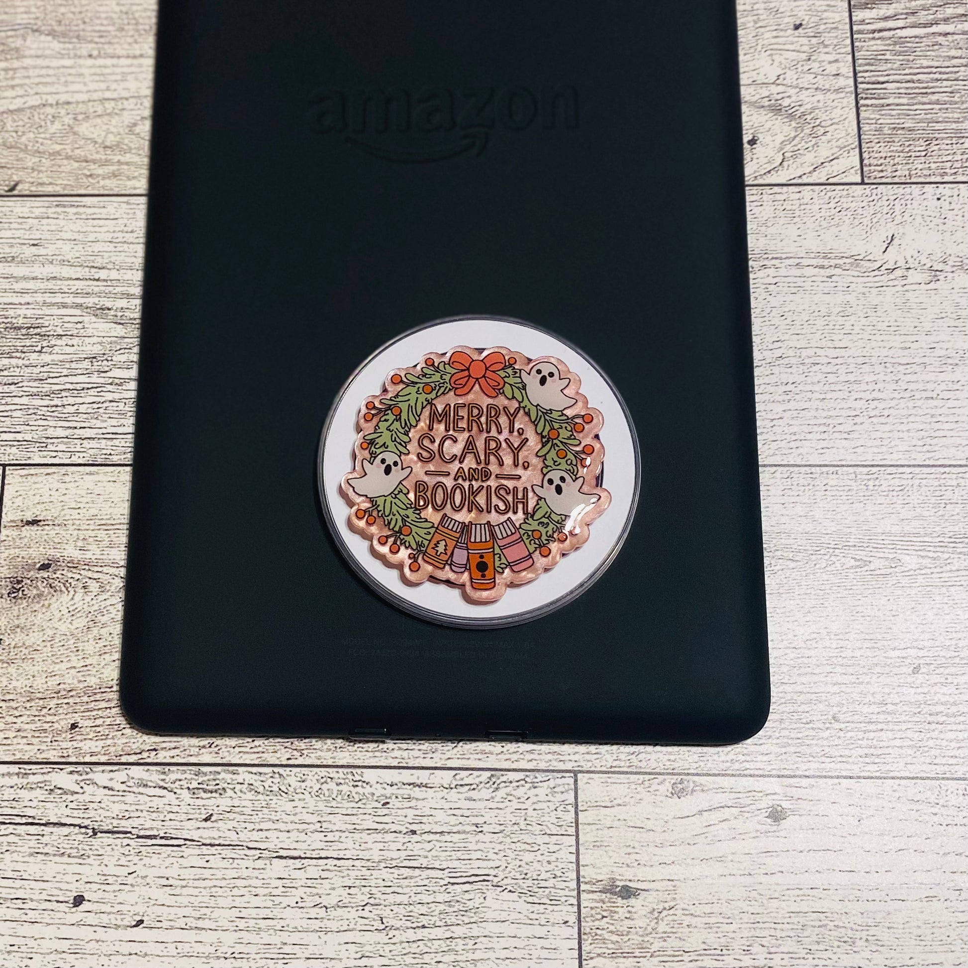 Merry Scary and Bookish magnetic e-reader phone grip on a checkered card with KALEX branding.