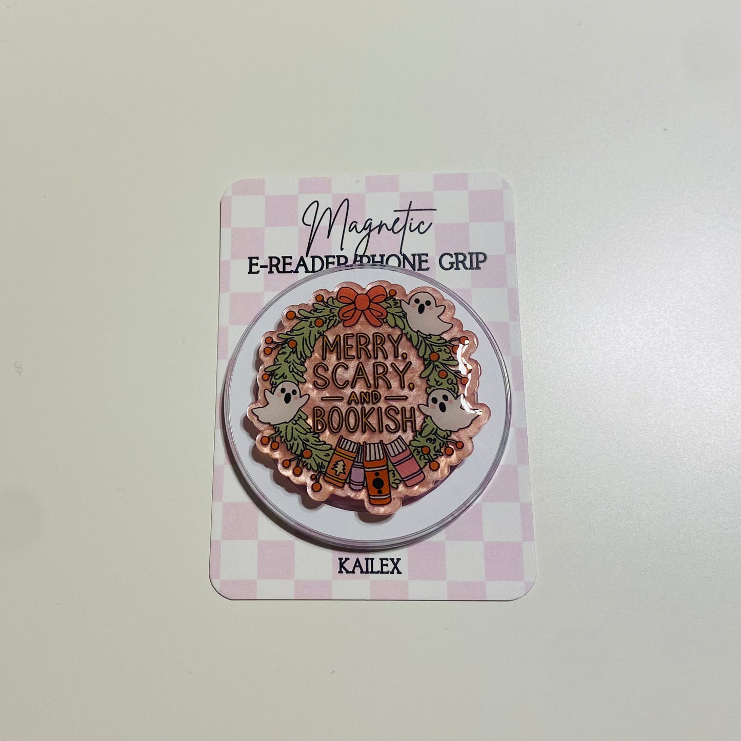 Merry Scary and Bookish magnetic e-reader phone grip on a checkered card with KALEX branding.