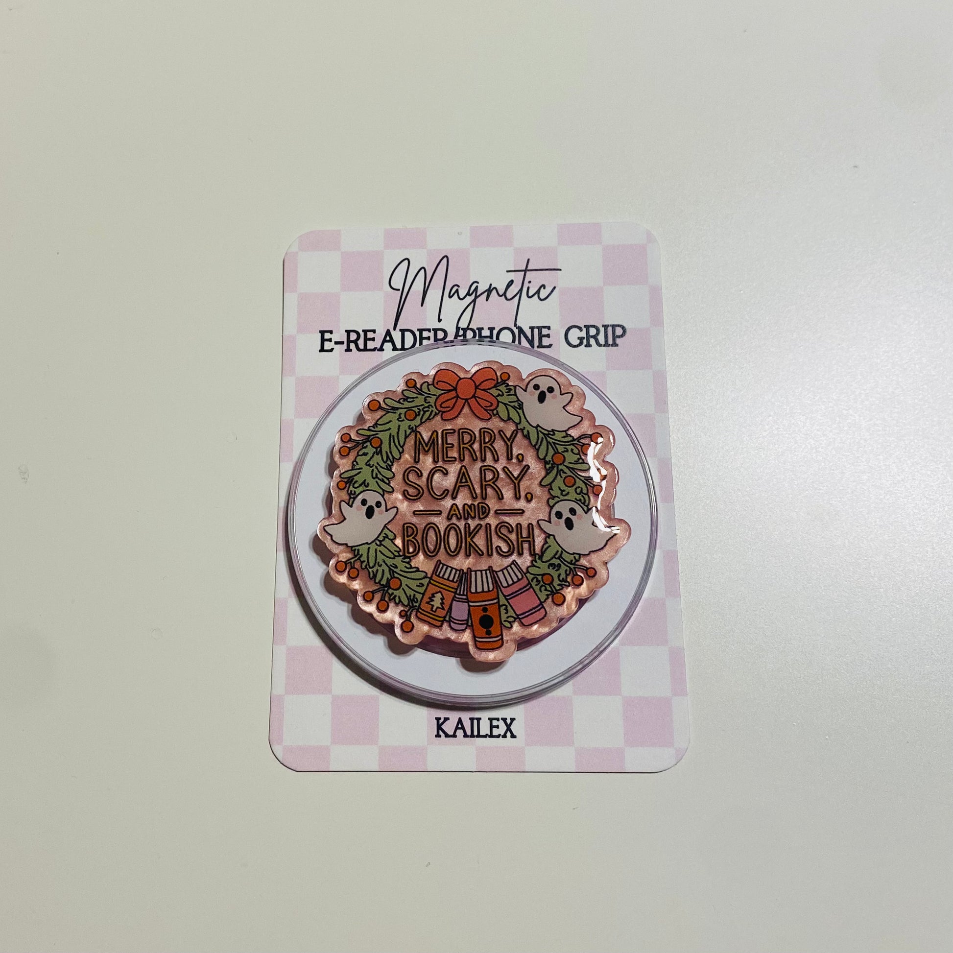 Merry Scary and Bookish magnetic e-reader phone grip on a checkered card with KALEX branding.