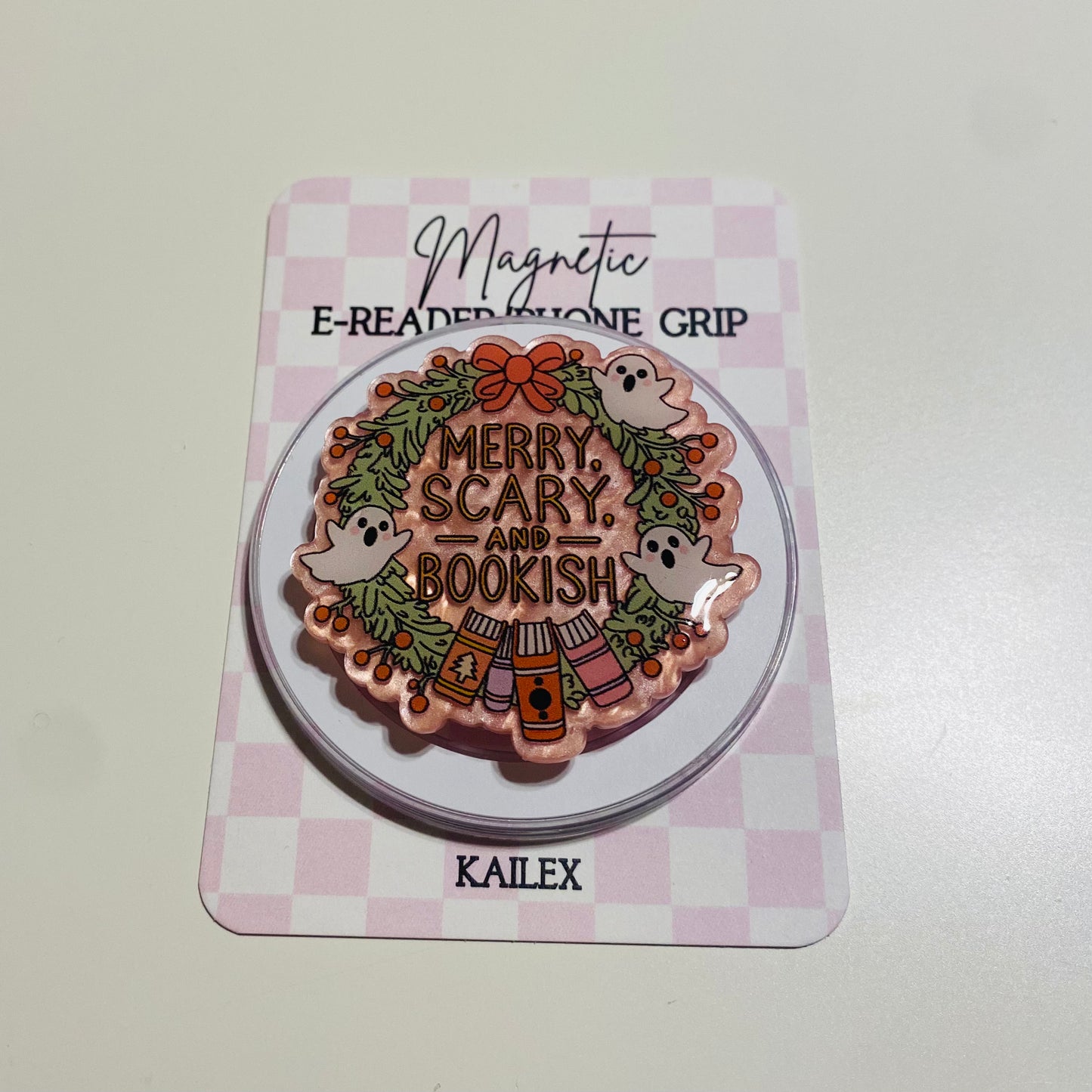Merry Scary and Bookish magnetic e-reader phone grip on a checkered card with KALEX branding.