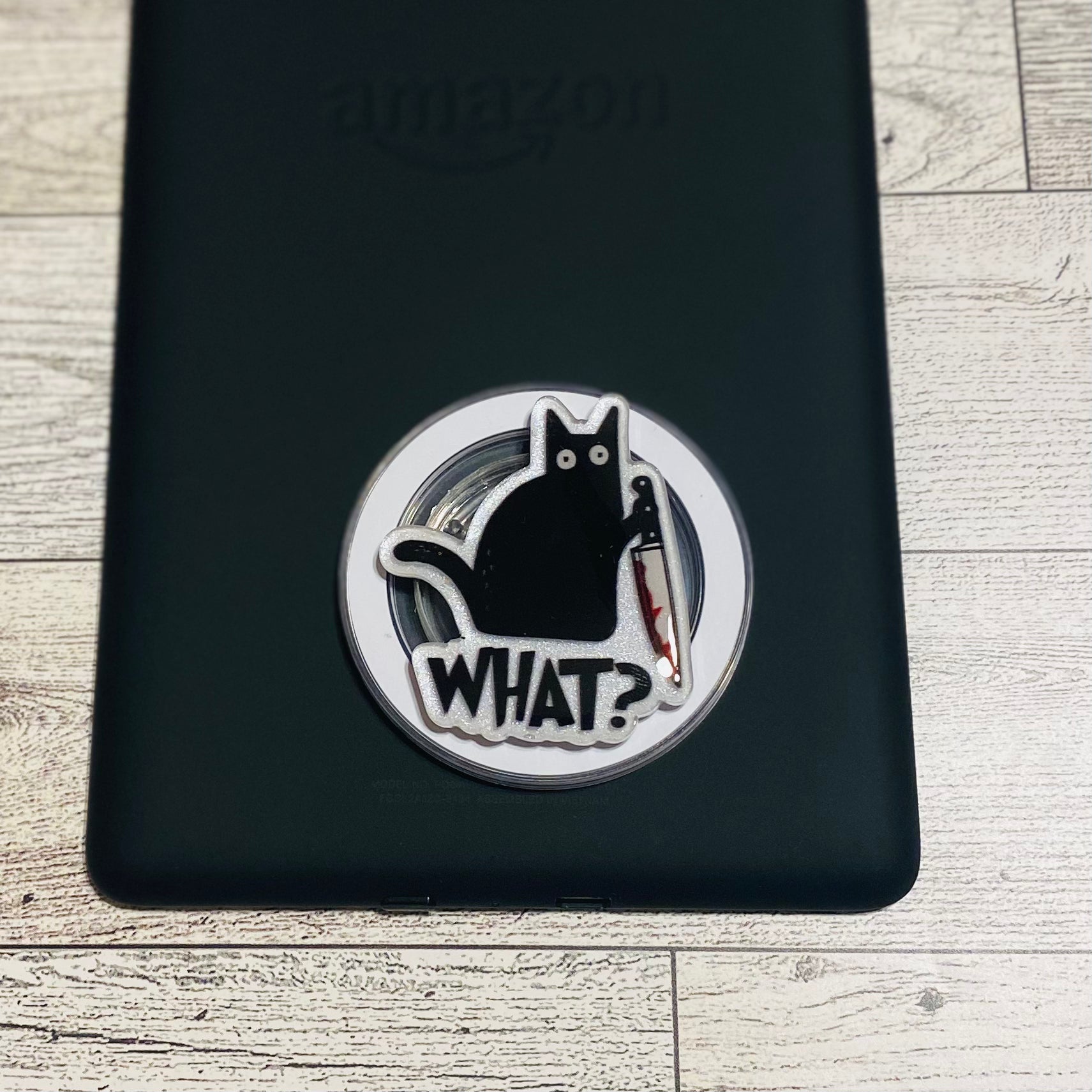 Magnetic e-reader phone grip with a black cat design on a checkered card