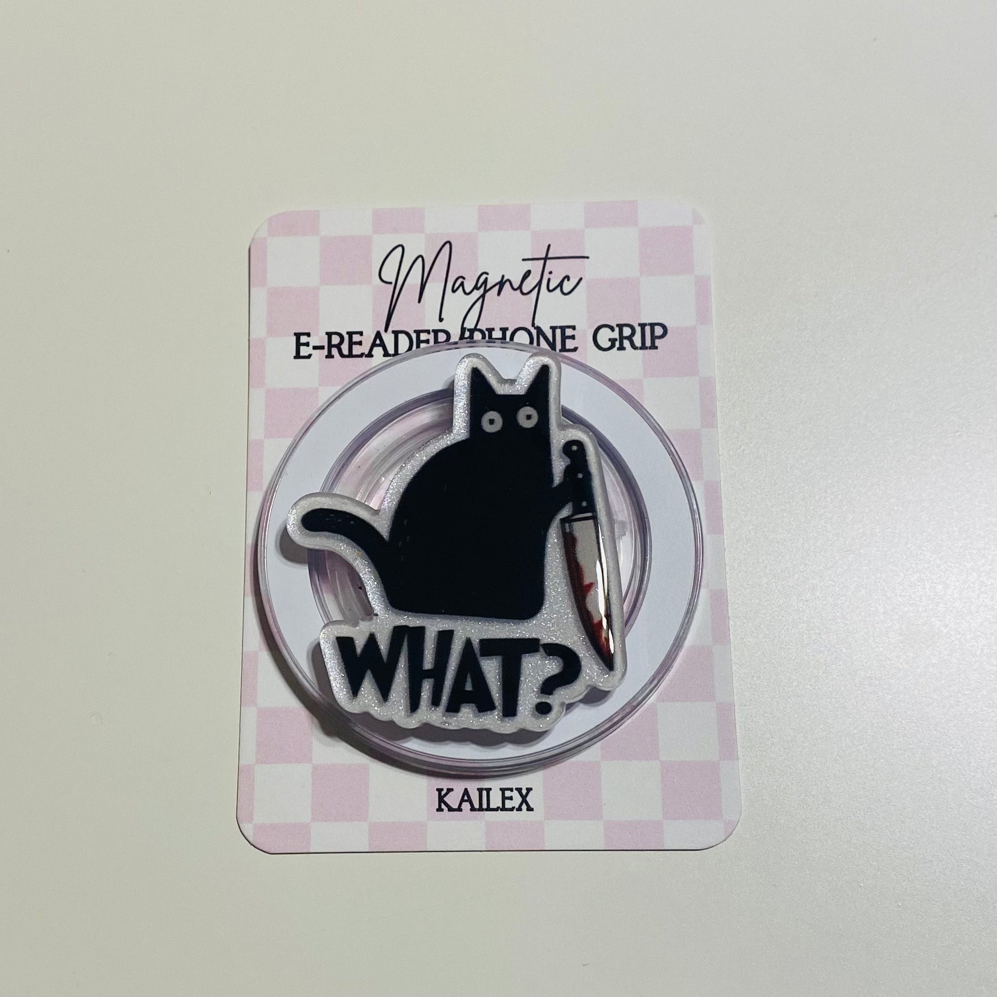 Magnetic e-reader phone grip with a black cat design on a checkered card