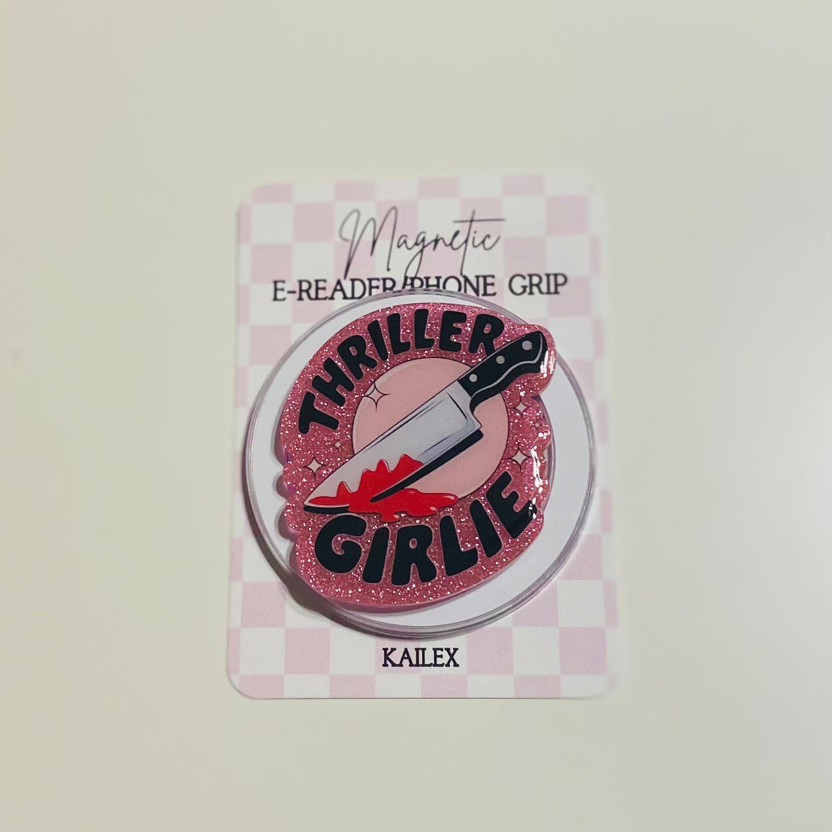 Pink glittery phone grip with 'Thriller Girlie' design on a checkered card, brand 'KAILEX' visible.
