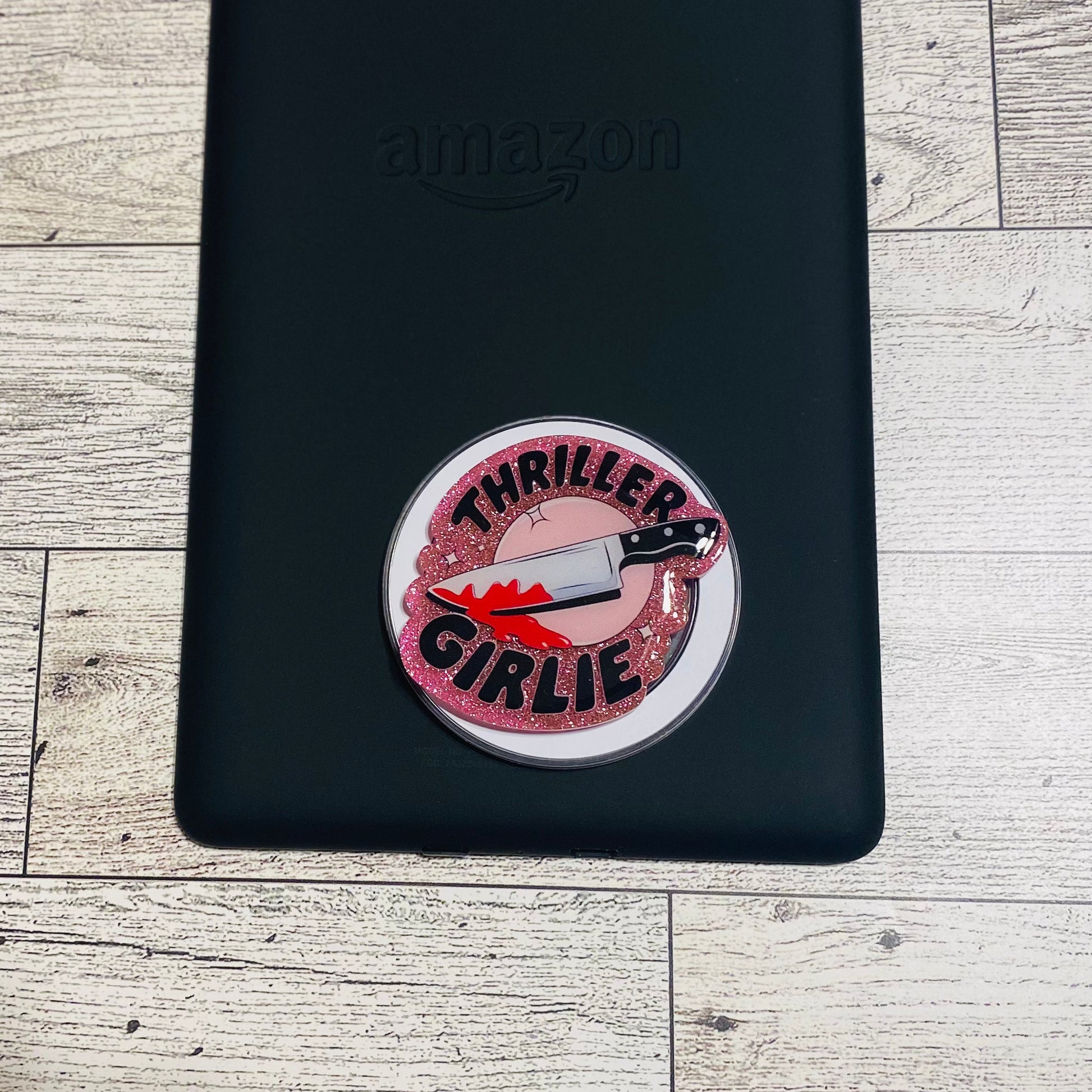 Pink glittery phone grip with 'Thriller Girlie' design on a checkered card, brand 'KAILEX' visible.