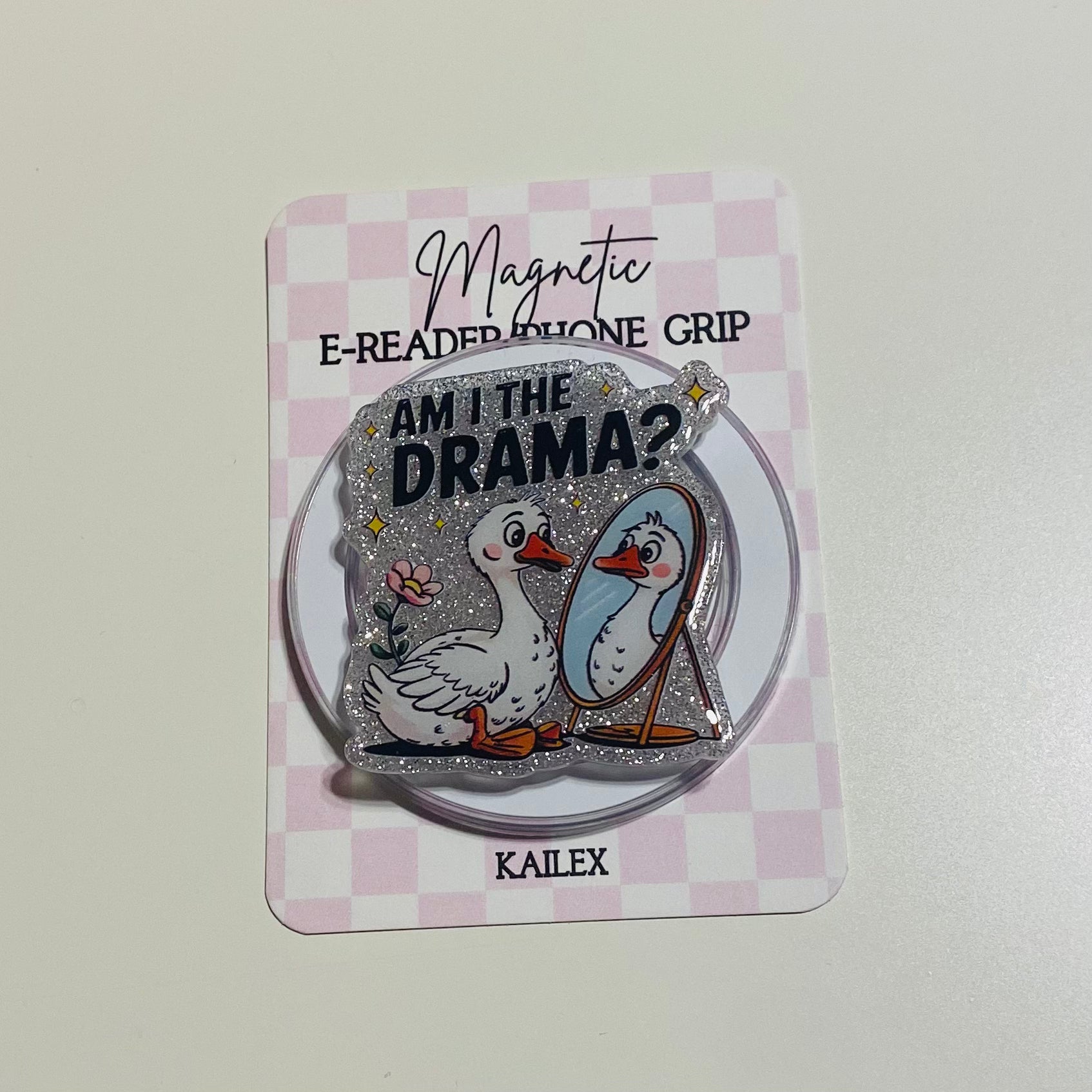 Magnetic e-reader phone grip with ducks and text on a checkered card