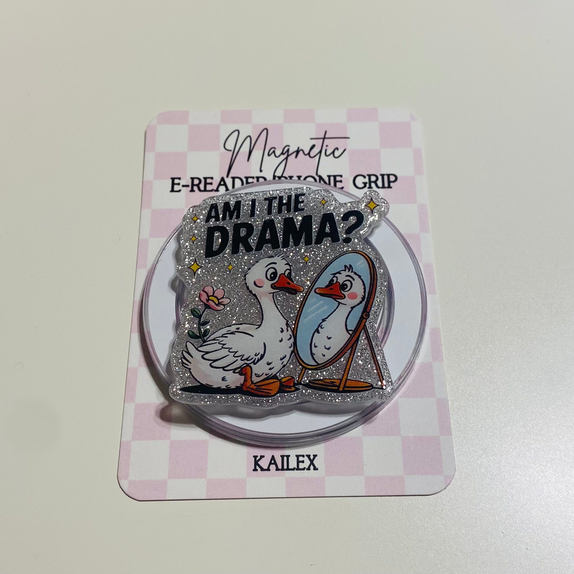 Magnetic e-reader phone grip with ducks and text on a checkered card